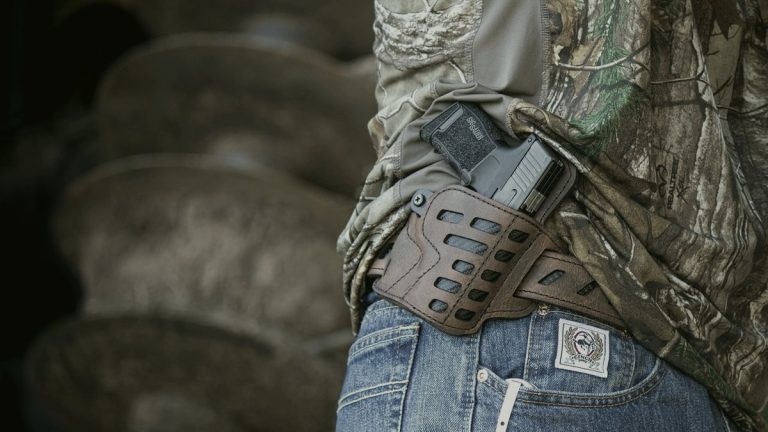 Pistol in a holster on a wooden table