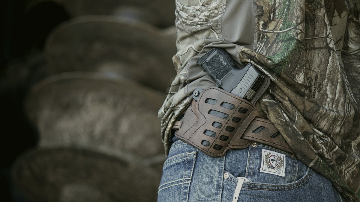 Pistol in a holster on a wooden table