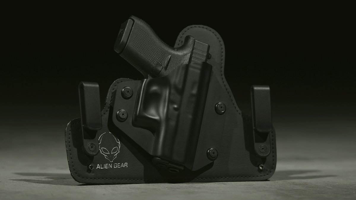 Black semi-auto pistol on a wooden counter