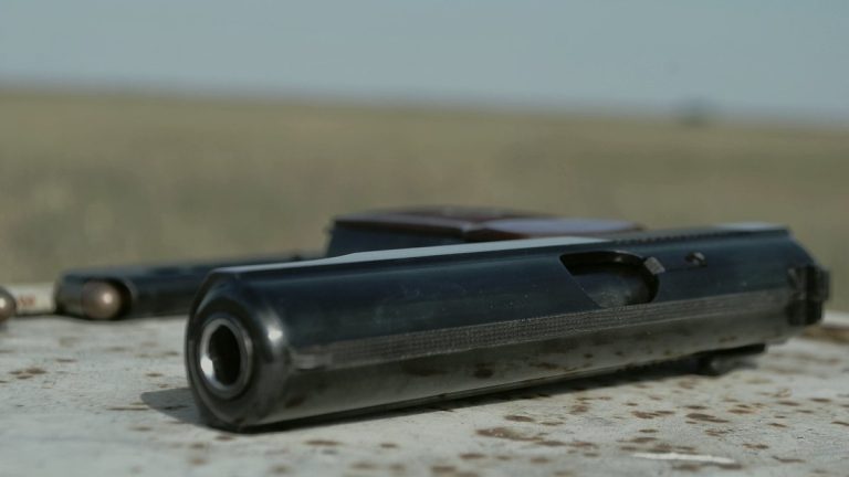 Unloaded pistol held in a training grip