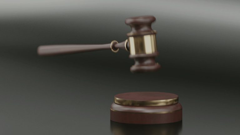 Judge's gavel resting on a desk in a courtroom