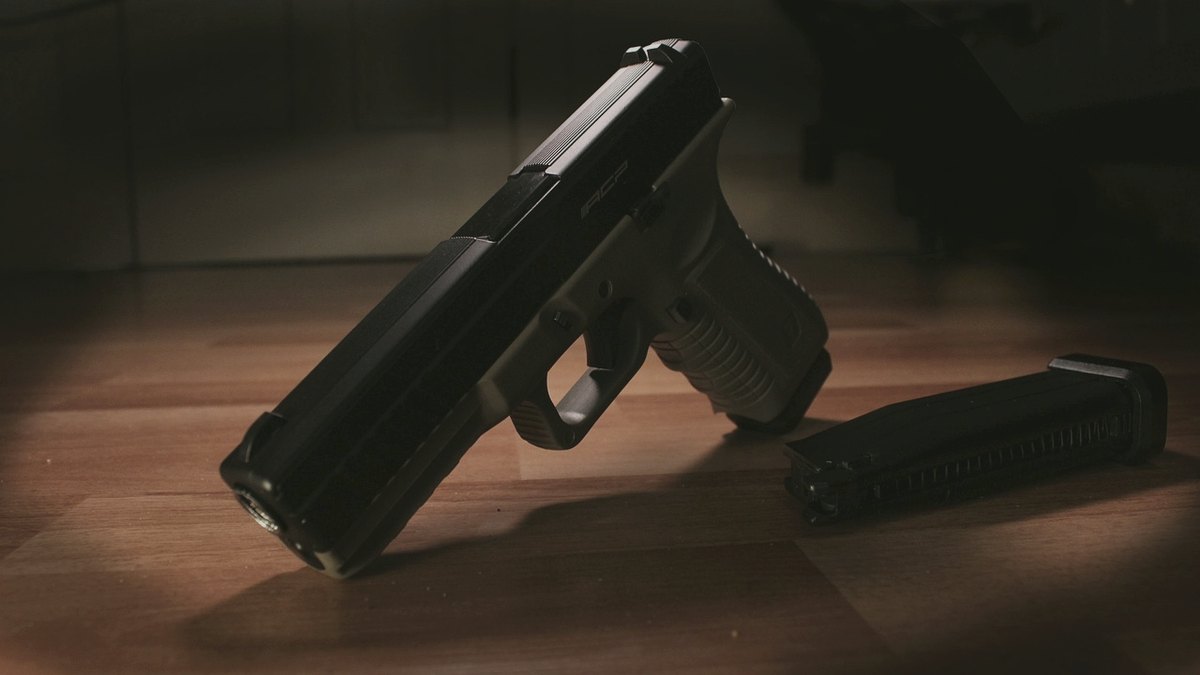 Semi-auto pistol and magazine in low dramatic light