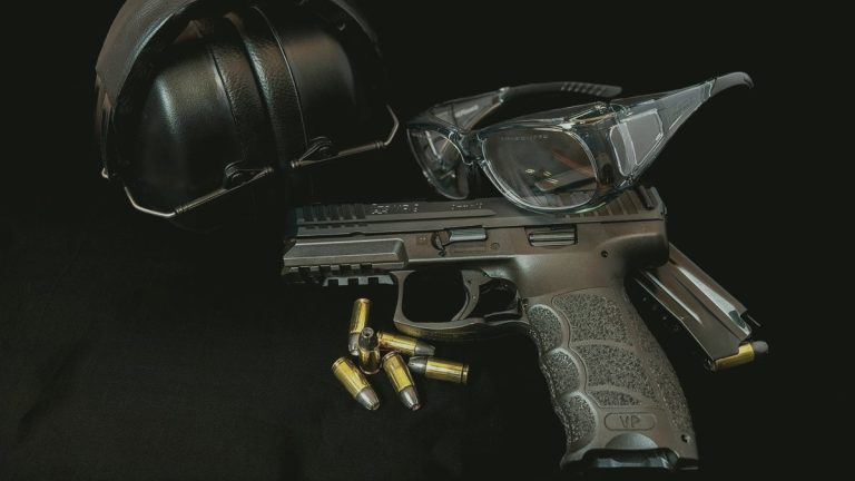 Pistol with ear protection, shooting glasses, and ammunition
